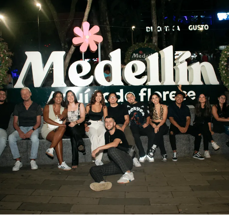 Local paisa guide leading tourists through Medellin Colombia nightlife clubs and rooftop bars at night