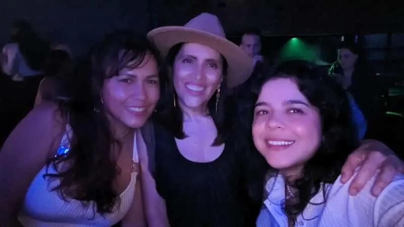 Tourists dancing and socializing at a Provenza rooftop bar on a Medellin Colombia nightlife experience tour